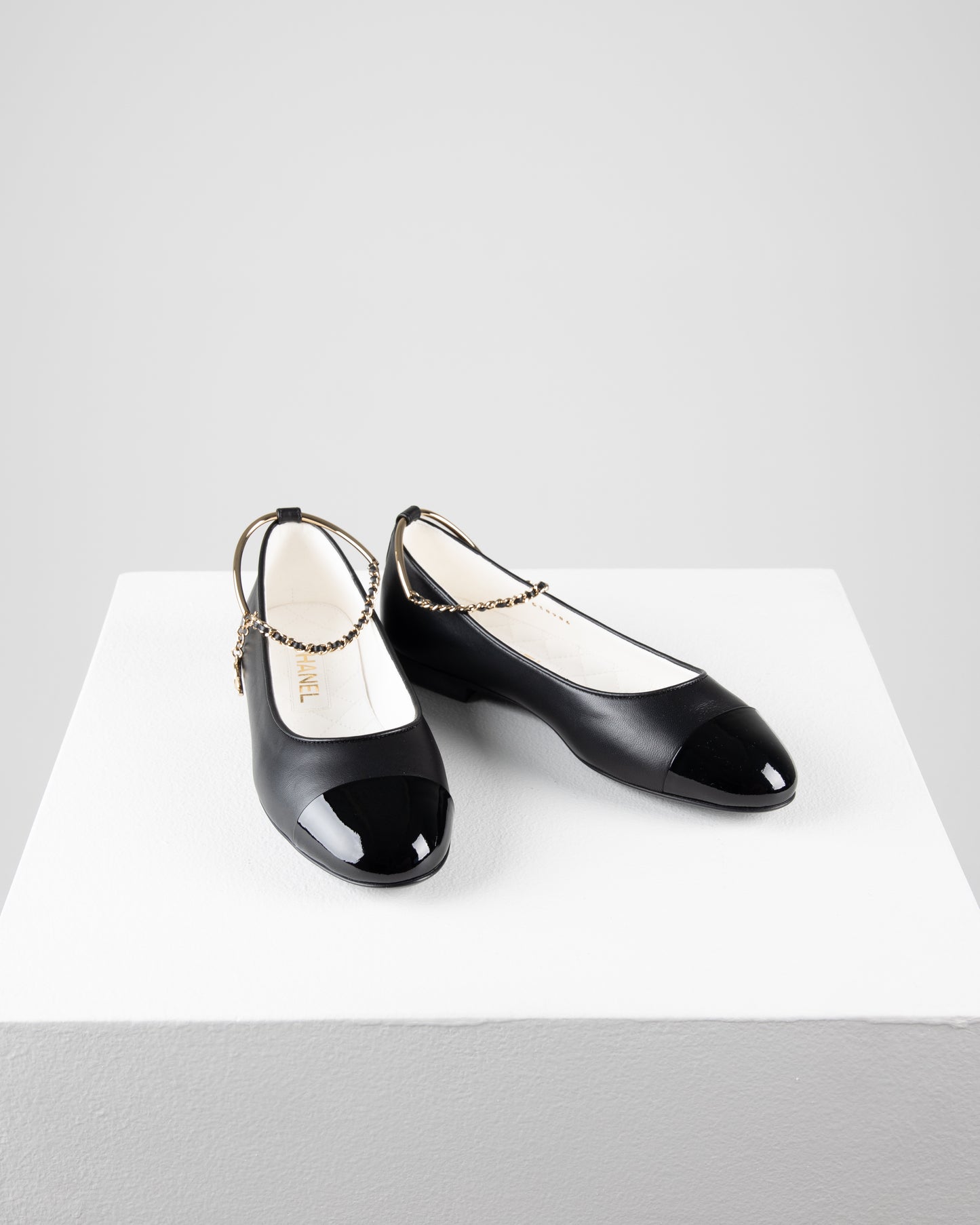 Chanel Ballerina Shoes in Black Leather with Patent Cap Toe and Chain Detail