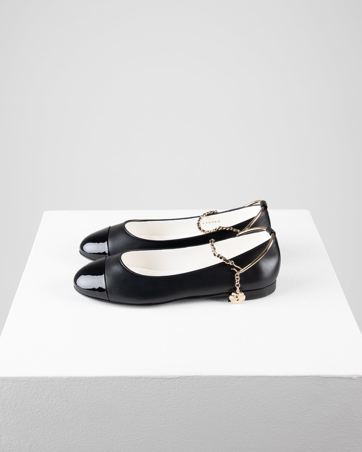 Chanel Ballerina Shoes in Black Leather with Patent Cap Toe and Chain Detail