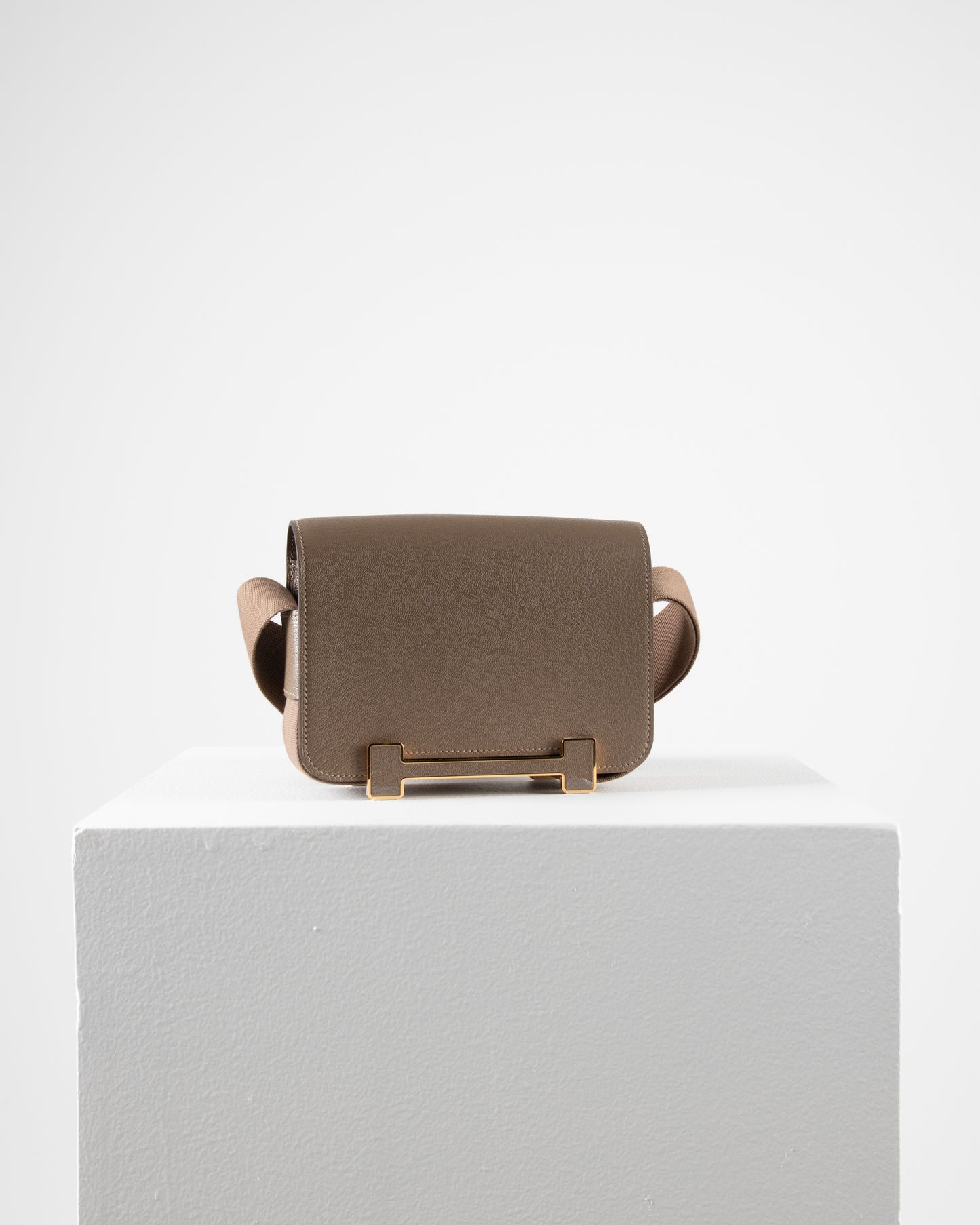 Geta Etoupe in Mysore Goatskin with Canvas Strap and Etoupe/Gold H Buckle