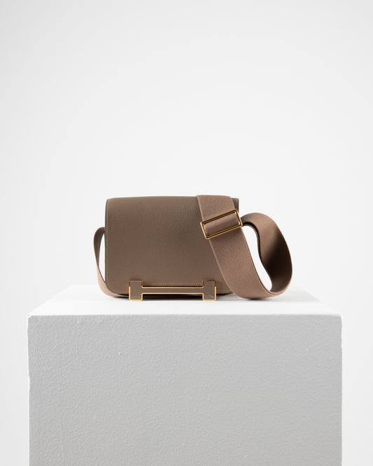 Geta Etoupe in Mysore Goatskin with Canvas Strap and Etoupe/Gold H Buckle