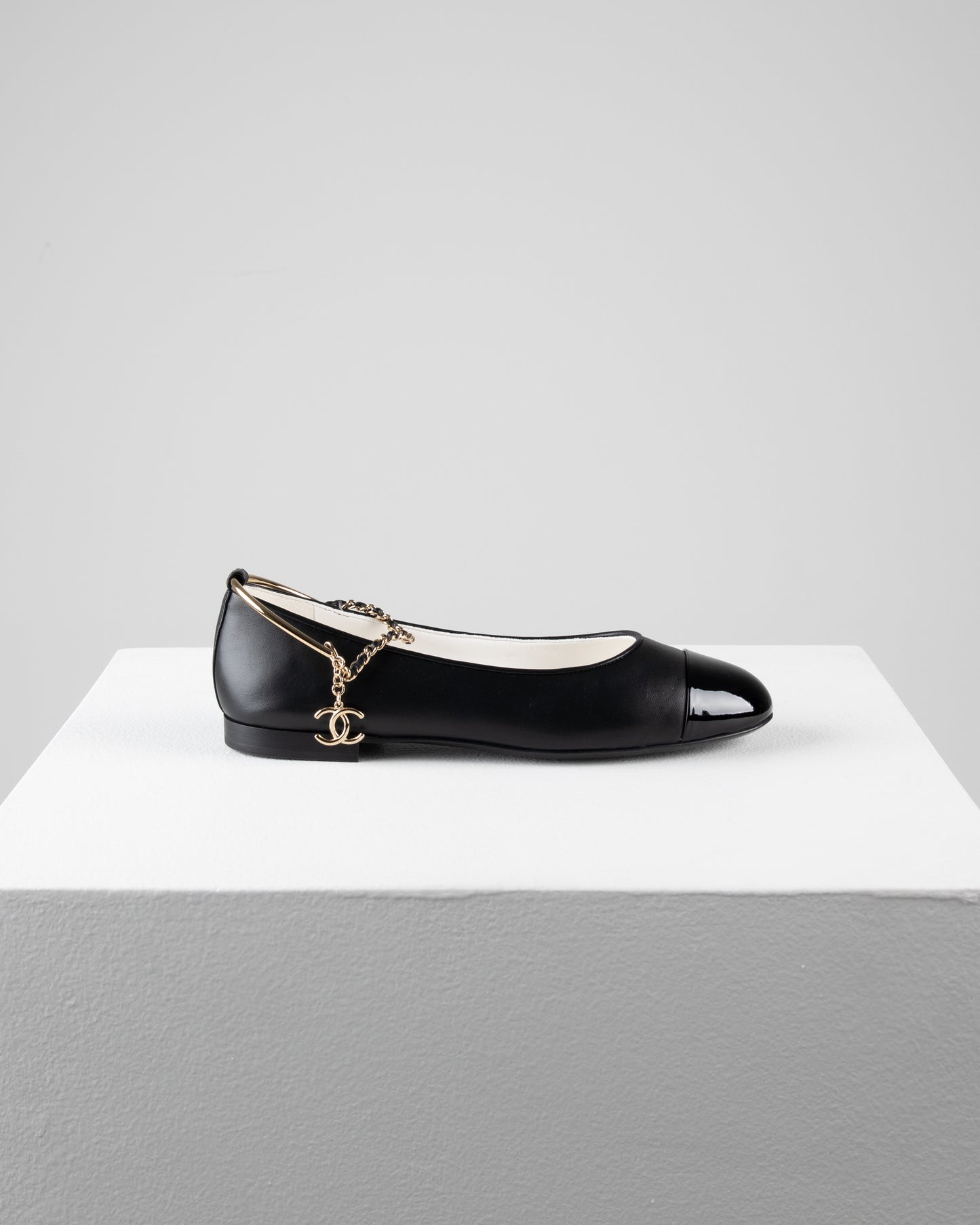 Chanel Ballerina Shoes in Black Leather with Patent Cap Toe and Chain Detail