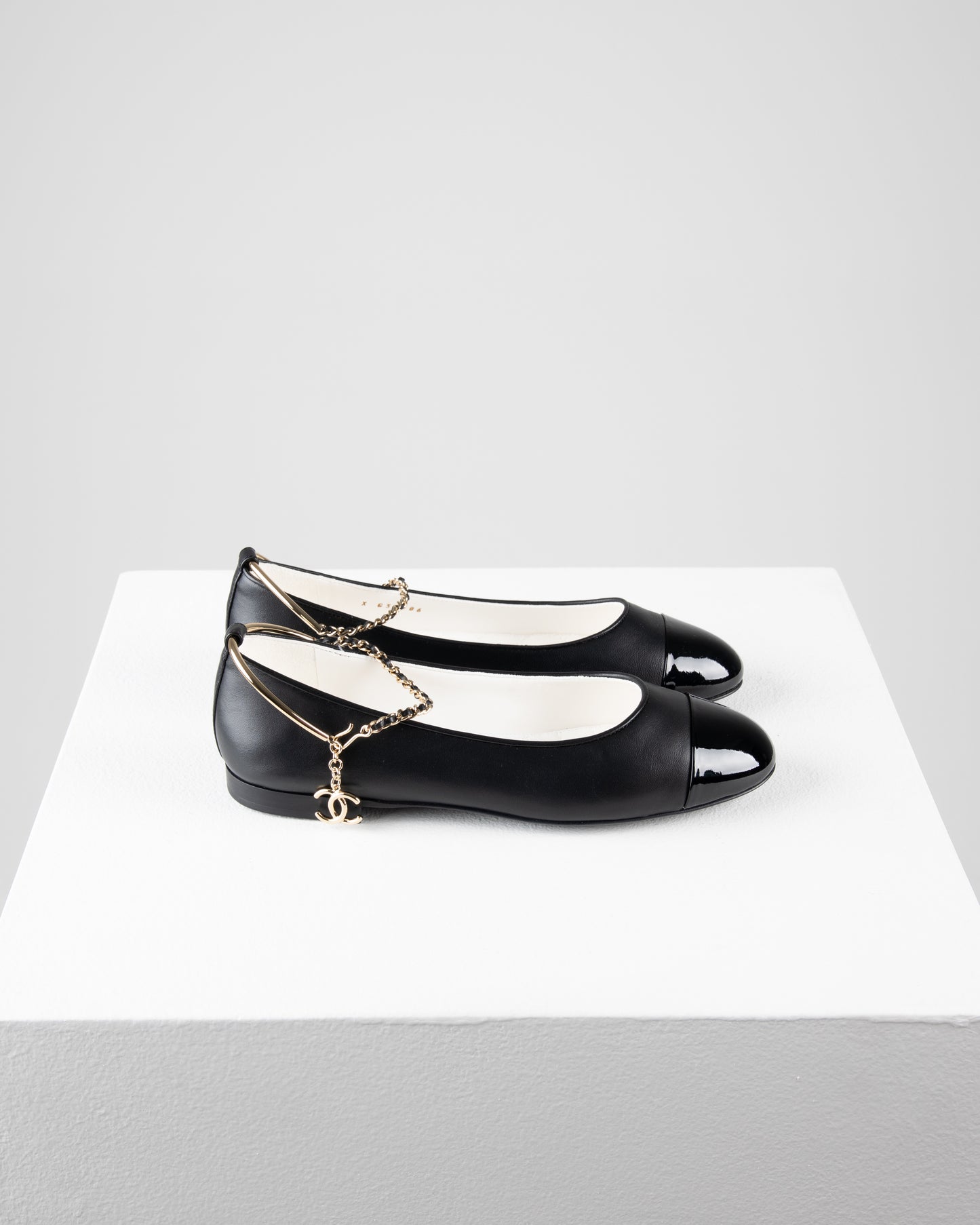Chanel Ballerina Shoes in Black Leather with Patent Cap Toe and Chain Detail
